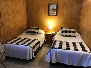 Letto o letti in una camera di Hotel Luanco