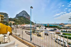 a balcony with a view of a city and a mountain at Hotel Porto Calpe in Calpe