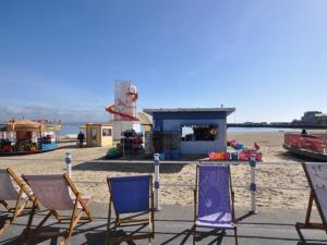 a group of chairs sitting on the beach at Sea Drift in Weymouth