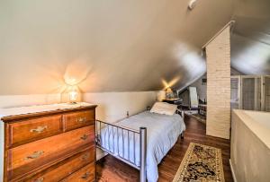 a bedroom with a bed and a dresser in a room at Explore Lake Erie and Strip From Quaint Apartment! in Geneva-on-the-Lake