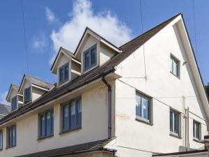 a white building with blue windows on top of it at 4 Armada House in Hope Cove