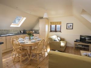 a kitchen and dining room with a table and chairs at 4 Armada House in Hope Cove