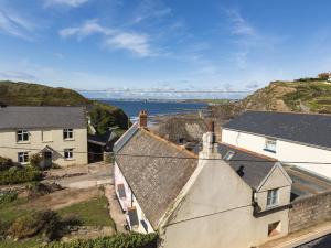 an aerial view of a house with the ocean in the background at 4 Armada House in Hope Cove