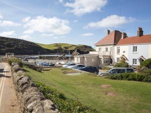 a group of cars parked in front of a house at 4 Armada House in Hope Cove