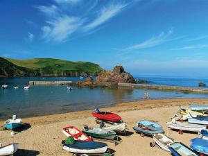 a group of boats sitting on a beach at 4 Armada House in Hope Cove