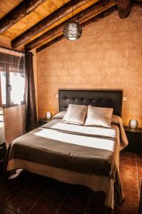 a bedroom with a large bed in a room at Apartamentos Rurales El Casarejo in Cantalojas