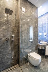 a bathroom with a shower with a toilet and a sink at 5 STAR APART HOTEL in Tbilisi City