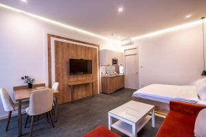 a hotel room with a bed and a living room at 5 STAR APART HOTEL in Tbilisi City