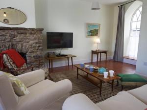 a living room with a couch and a fireplace at Chapel House in Dartmouth