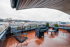 a balcony with furniture and a view of a city at Amsterdam Lviv Apartments in Lviv