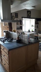 a kitchen with a stove and a counter top at LA MESONNETTA in Soulignonne