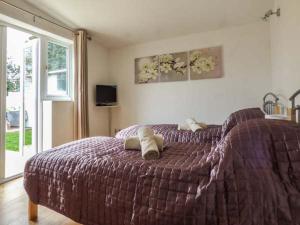 a bedroom with a bed with two towels on it at The Old Clockmakers in Norwich