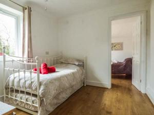 a bedroom with a bed with a red stuffed animal on it at The Old Clockmakers in Norwich