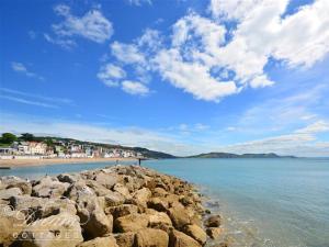 a view of a beach with rocks in the water at Valley View Farm Annexe in Uplyme