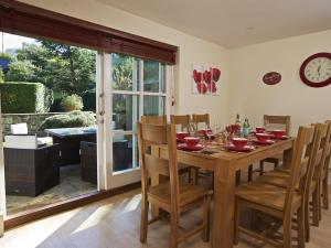 a dining room with a wooden table and chairs at 1 Combehaven in Salcombe