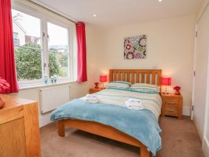 a bedroom with a bed and a window at 1 Combehaven in Salcombe