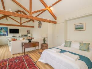 a bedroom with a bed and a living room at The Cider Barn in Warminster