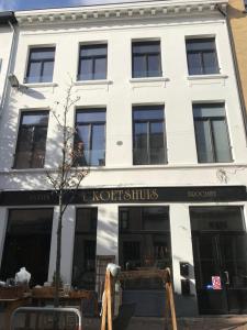 Un bâtiment blanc avec un panneau kottitzidis sur lui dans l'établissement Kloosterloft, à Anvers