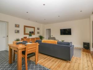 a living room with a couch and a table at Hillcrest in Newton Stewart