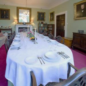 a long table with white plates and silverware on it at Parnacott in Pancrasweek