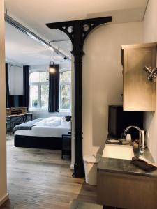 a bedroom with a bed and a kitchen with a sink at KunstWerk B in Trossingen +78 photos