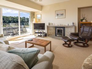 a living room with a couch and a fireplace at 5 Fairhaven in Salcombe