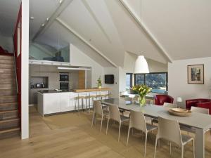 a dining room and kitchen with a table and chairs at Woodwell in Salcombe