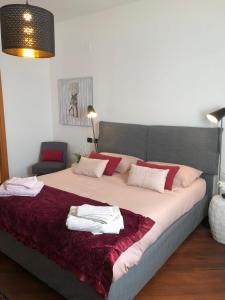 a bedroom with a large bed with towels on it at Nativo Suite Da Vinci 25 in Fiumicino