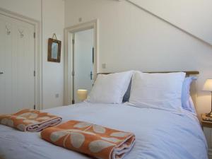 a white bed with two pillows on top of it at 9 Prospect House in Kingsbridge