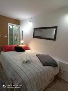 a bedroom with a large bed and a mirror at Apartments Vrime in Biograd na Moru
