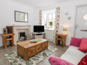 a living room with a couch and a coffee table at Little Daisy Cottage in Hornsea