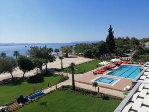 a view of the pool and the ocean from the balcony of a hotel at Doğruer Hotel & Spa in Muğla