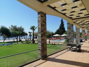 a patio with a table and chairs and a view of a park at Doğruer Hotel & Spa in Muğla