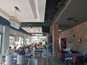 a dining room with people sitting at tables at Doğruer Hotel & Spa in Muğla