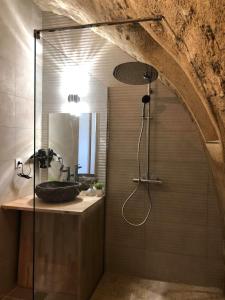 a bathroom with a shower with a sink and a mirror at Paradise Love In Provence - loft en pierres - spa privatif in Reillanne