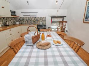 a kitchen with a table with a plate of food on it at The Old Workshop in Castleton