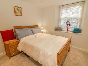 a bedroom with a large bed and a window at Flat 2 Galloway House in Kendal