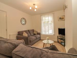 a living room with a couch and a table at Sunvale in Teignmouth
