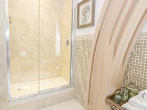 a bathroom with a shower with a glass door at Penthouse St Mary's Church in Moffat +21 photos