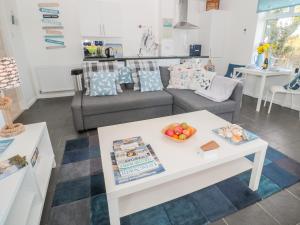 a living room with a couch and a table at Bracken Barn Cottage in Morpeth