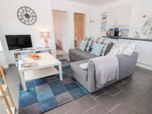 a living room with a couch and a table at Bracken Barn Cottage in Morpeth