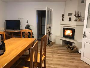 a dining room with a table and a fireplace at Прикарпаття in Kosiv