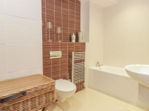 a bathroom with a toilet and a sink at Apartment 1 St Mary's Church in Moffat +12 photos