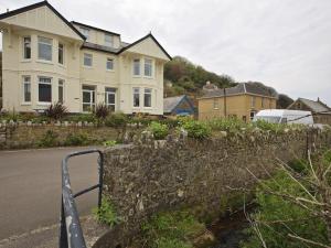 a stone fence in front of a house at Cove View in Kingsbridge