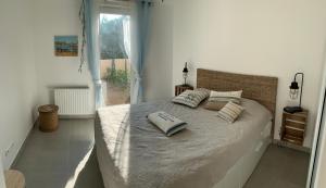 a bedroom with a bed with two pillows on it at Boost Your Immo Six Fours Les Plages 231 in Six-Fours-les-Plages
