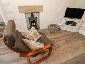 a living room with a couch and a fireplace at The Landings in Kirkby Lonsdale