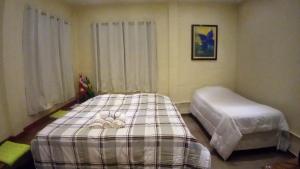 En eller flere senge i et værelse på Loft Aconchegante