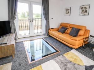 a living room with a couch and a tv at Lock View in Skipton