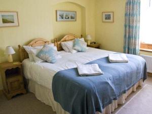 a bedroom with a bed with two towels on it at Bridle Cottage in Settle