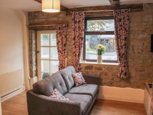 a living room with a couch and a window at Pinner's Cottage in Knighton